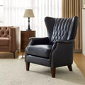 Poltrona a pozzetto in vera pelle con borchie decorative e gambe in legno massello, blu nautico