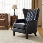 Poltrona a pozzetto in vera pelle con borchie decorative e gambe in legno massello, blu nautico